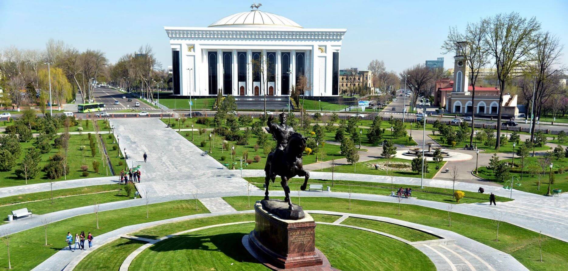 Amir Timur equestrian monument in the central green square with Hotel Uzbekistan in Tashkent